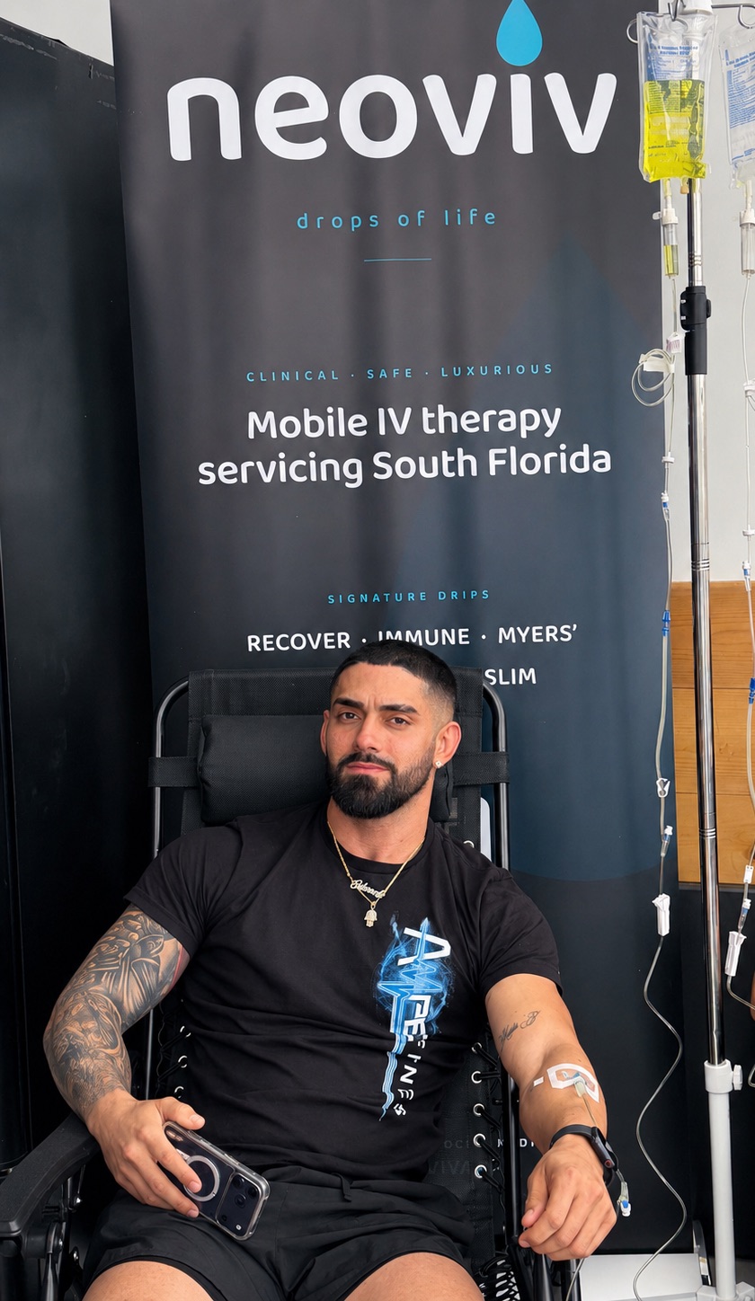 NeoViv event setup with IV therapy chair and branded banner