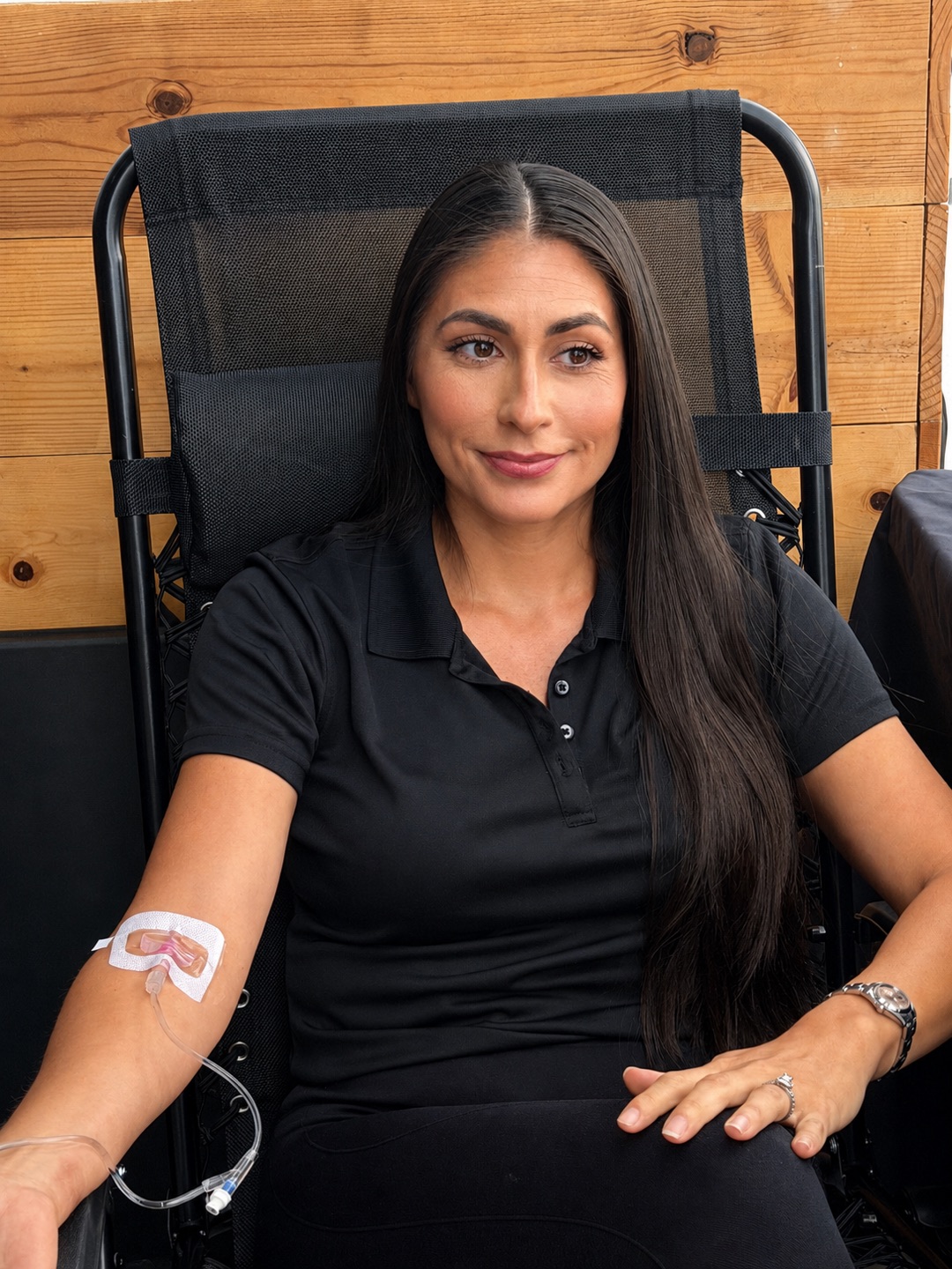 Client receiving a concierge IV visit in a lounge chair